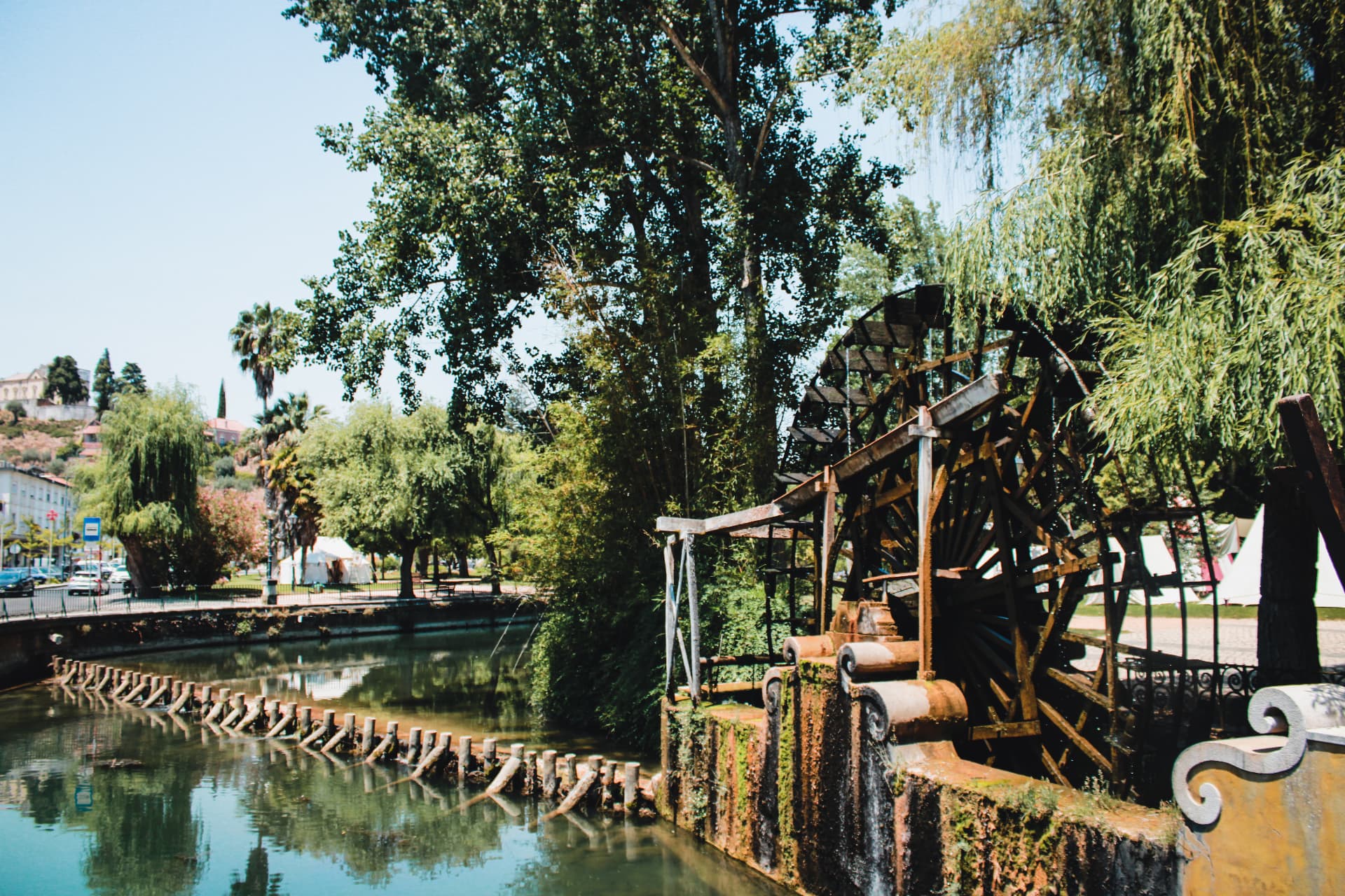 Old water wheel beside the Nabão river in Tomar