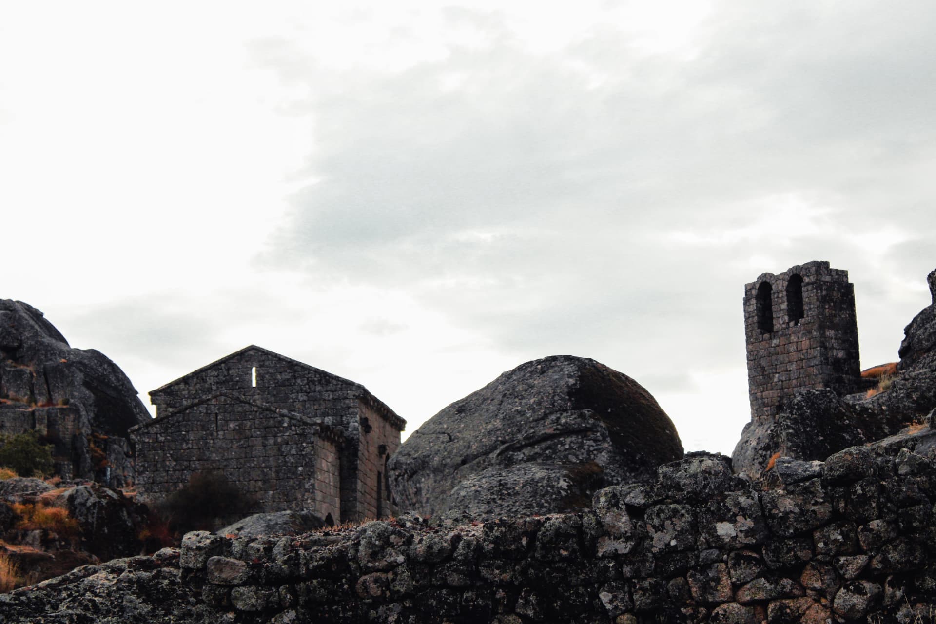 Stone chapel and bell tower among granite boulders in Portugal