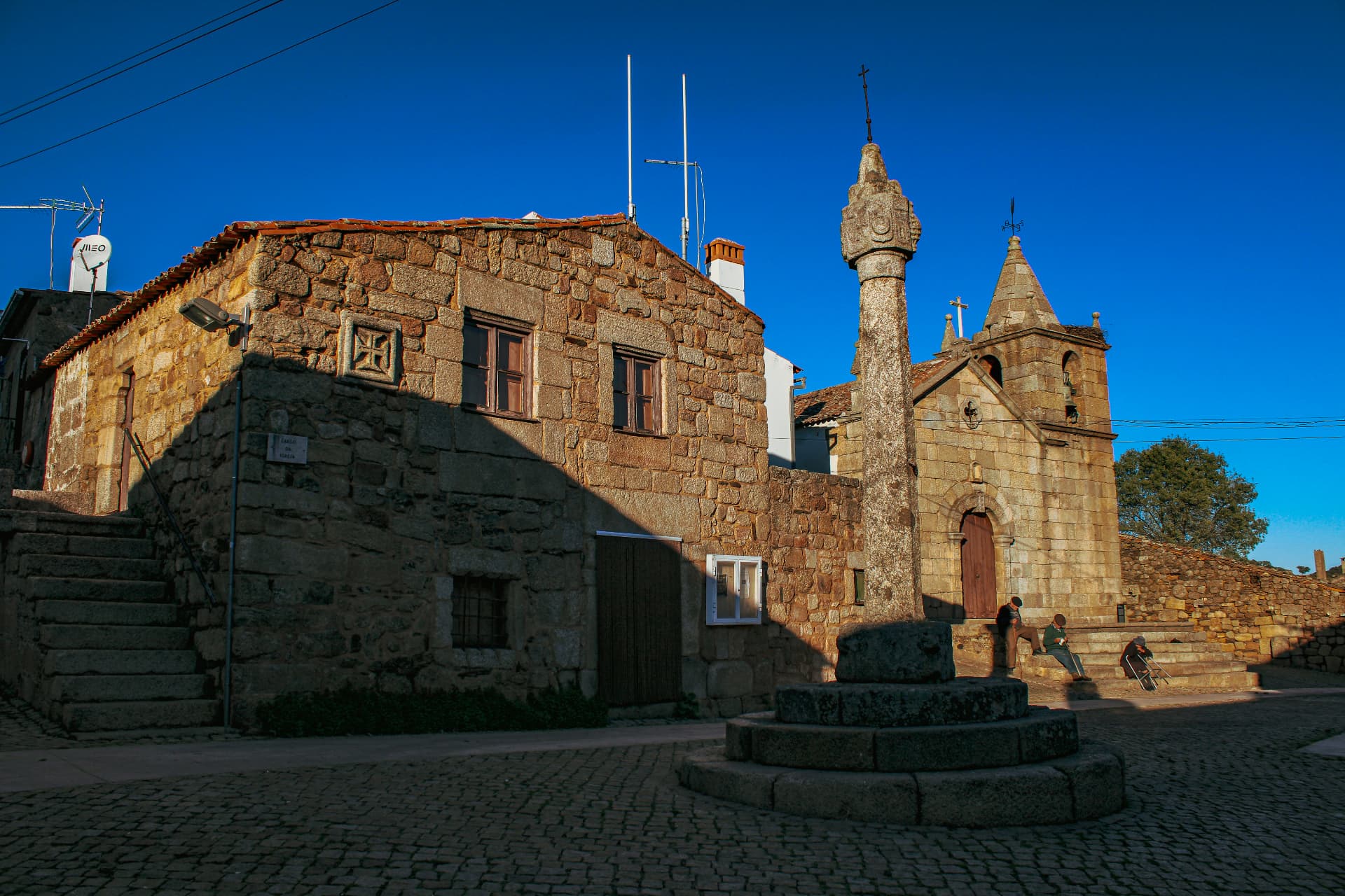 The pillory and the parish church in the cobbled square of Idanha-a-Velha